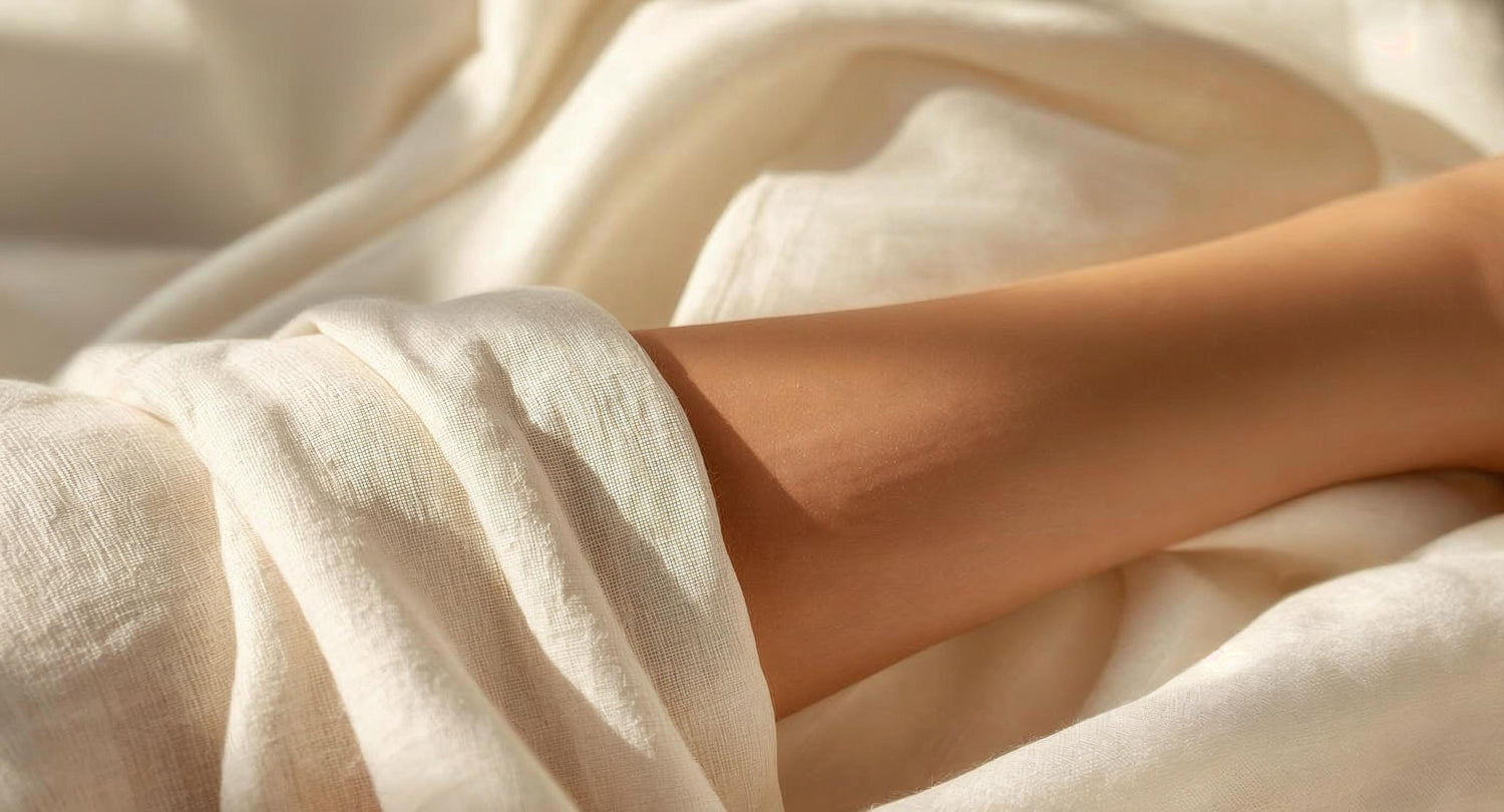 Close-up of a person's hand wrapped in soft, beige fabric